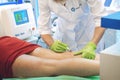 Kiev, Ukraine Ã¢â¬â 19 September, 2018: Diode laser for treating vessels. Varicose laser treatment on female legs during beauty show